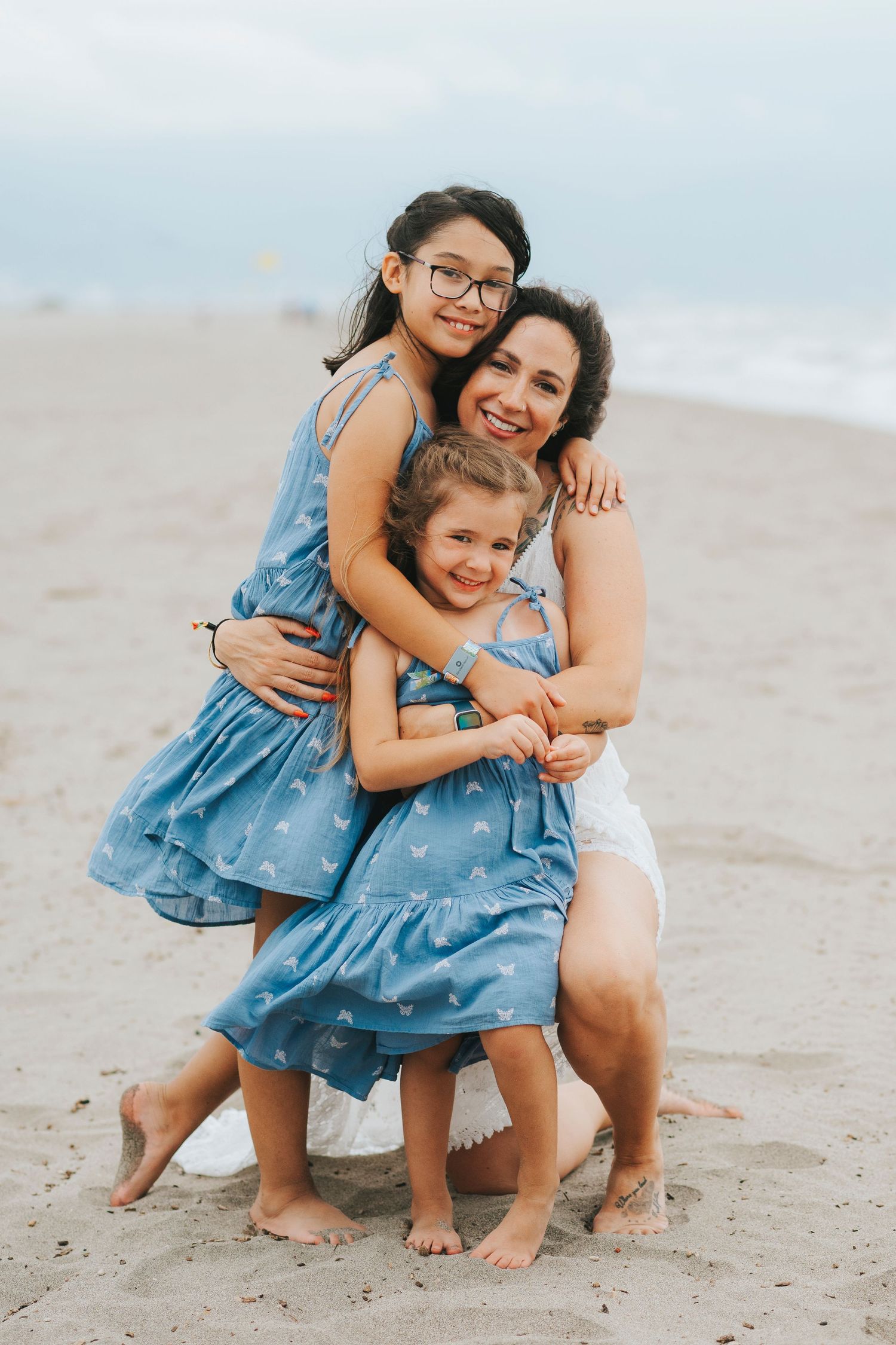 Tender family moment captured while playing together on a sandy beach.