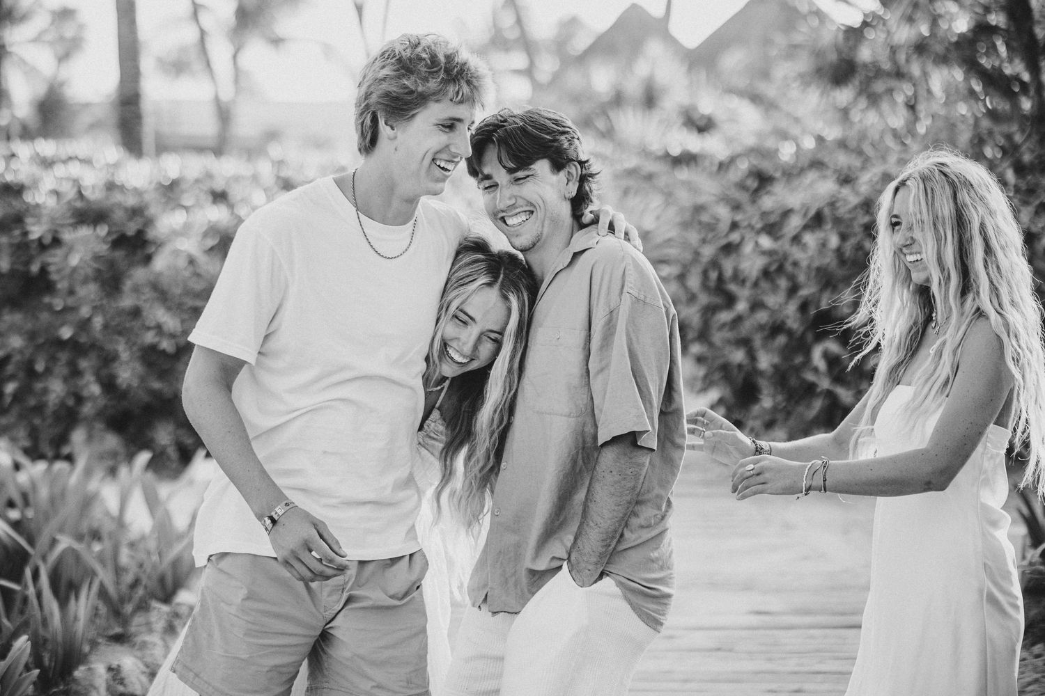 Romantic couple shares tender moments in a series of black and white photos outdoors.