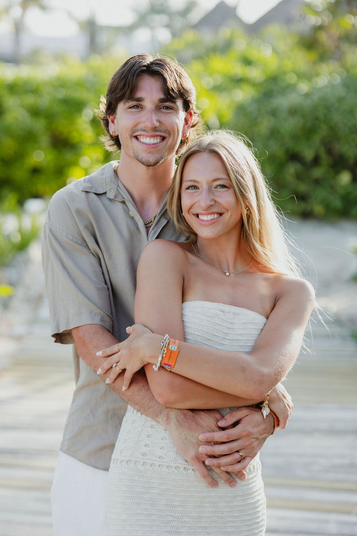 Couple embracing and laughing together on a sunny tropical day.