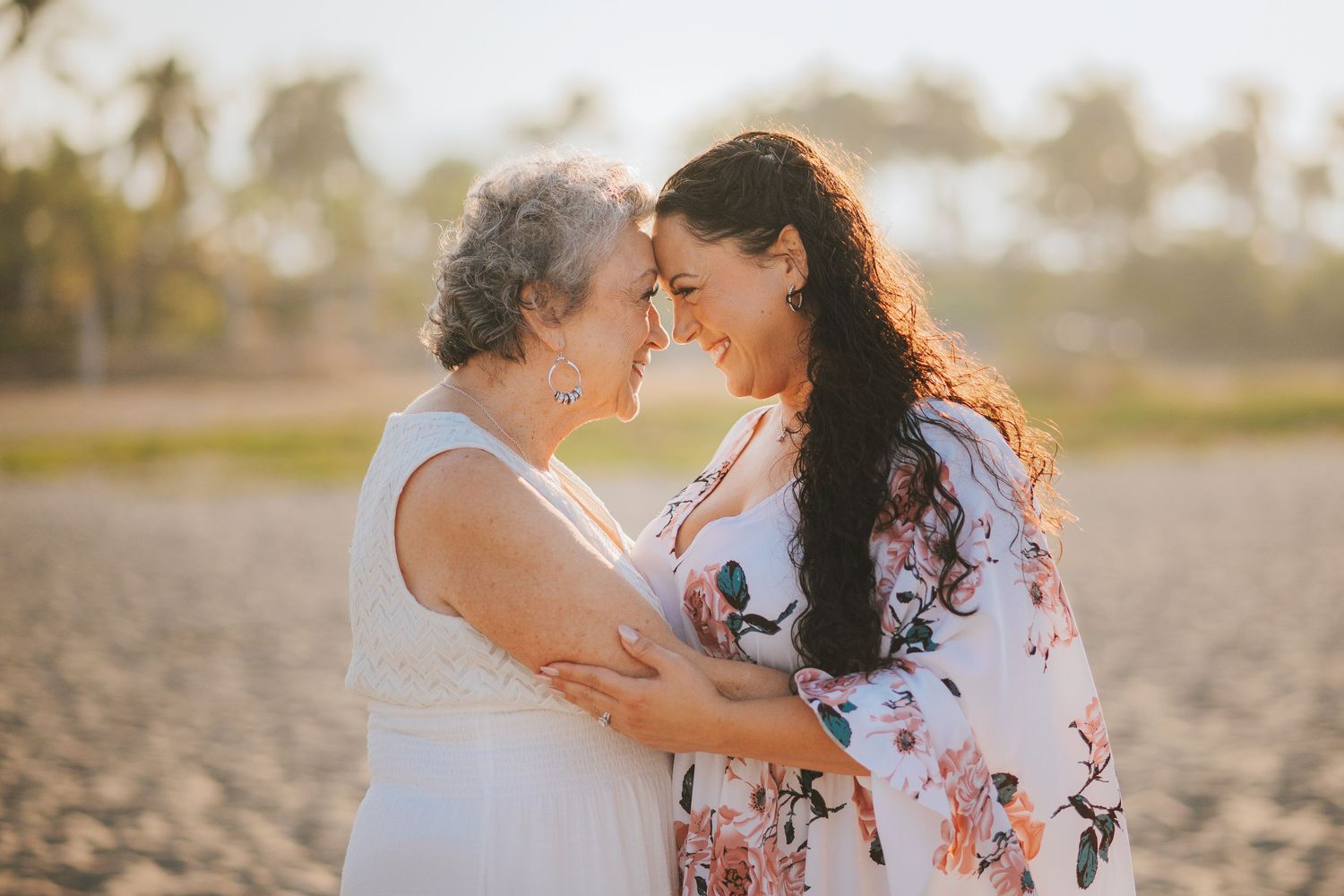 Romantic couples sharing tender moments in a tropical setting during golden hour.