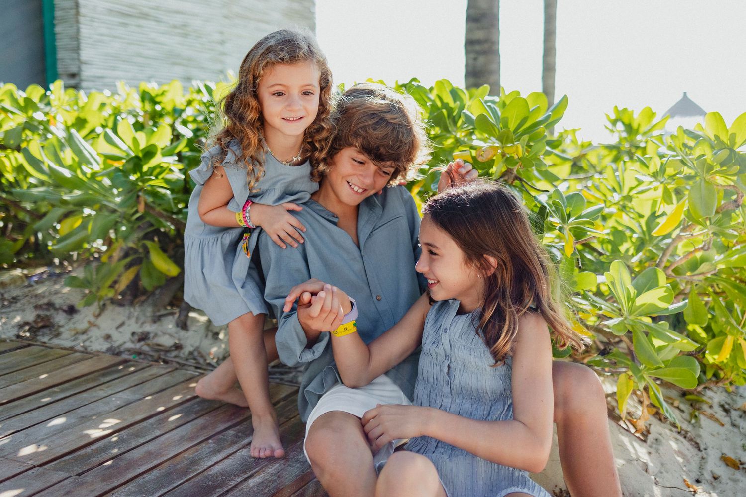 Family bonding moments captured on a lush tropical beach setting.