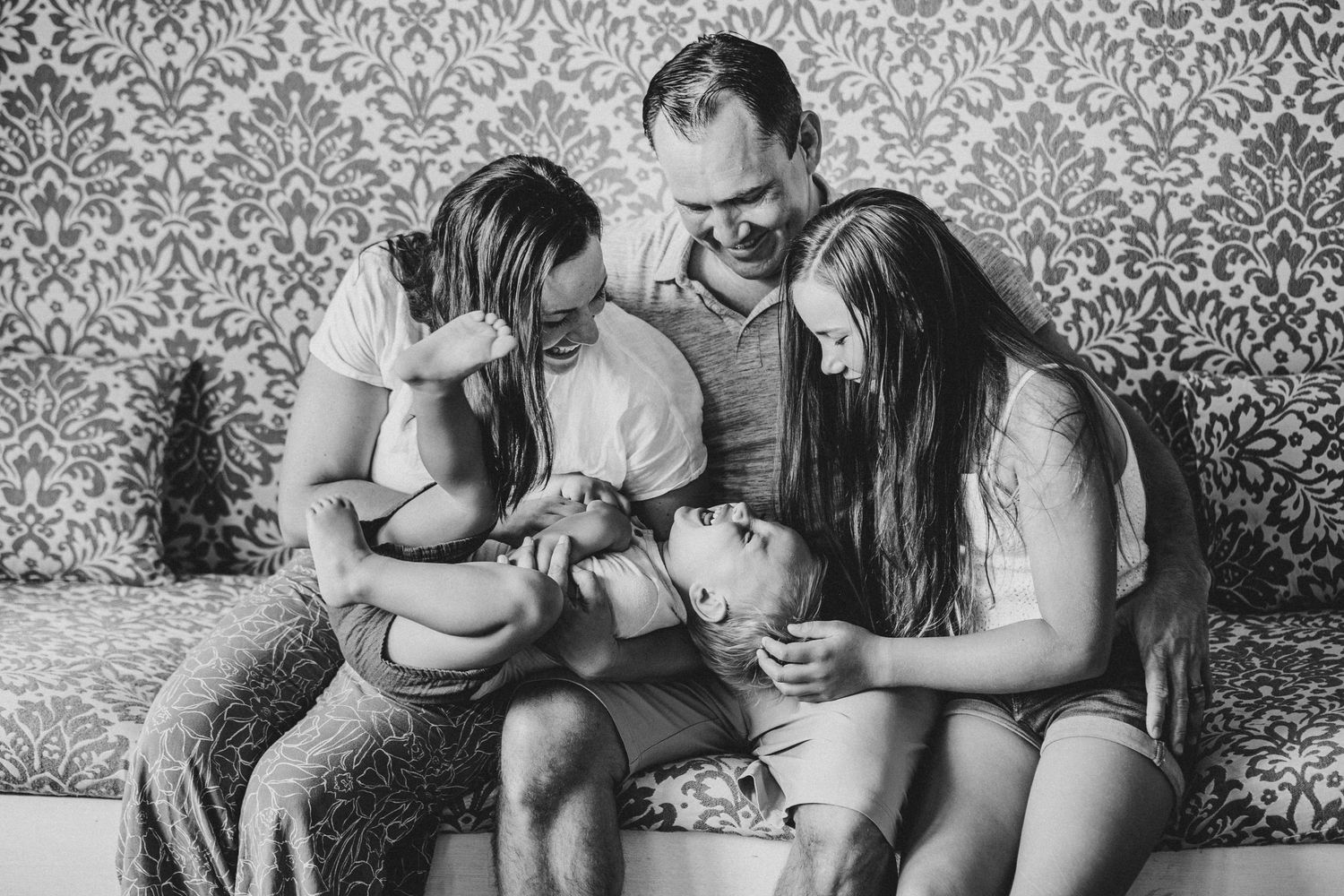 Black and white photo montage showing tender moments between parent and child in intimate home settings.