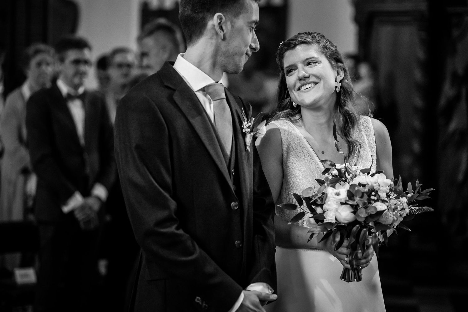 A black and white wedding photo collage showing candid moments of celebration and romance at a formal ceremony.