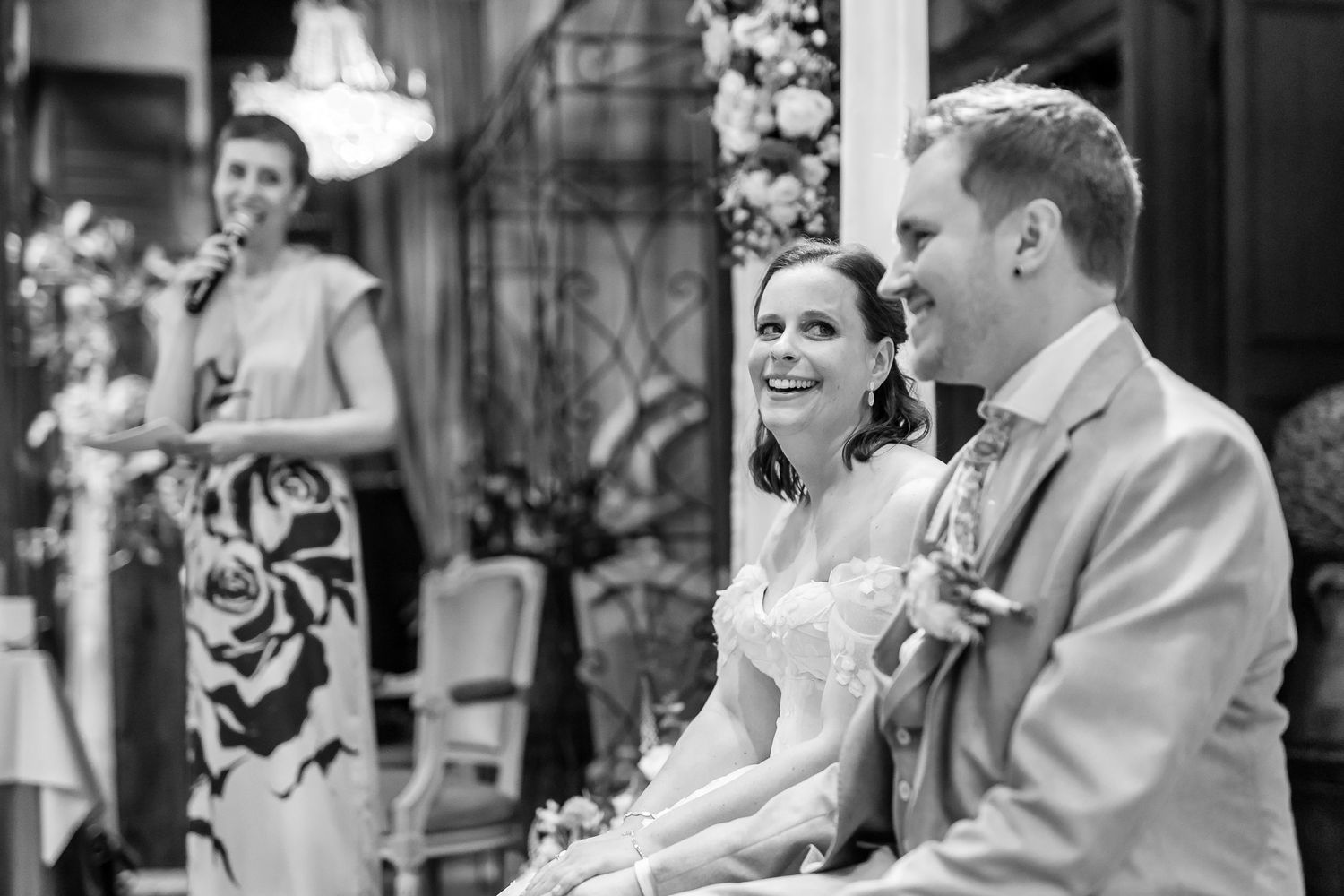A black and white photo collage showing candid moments from a wedding celebration with dancing and laughter.