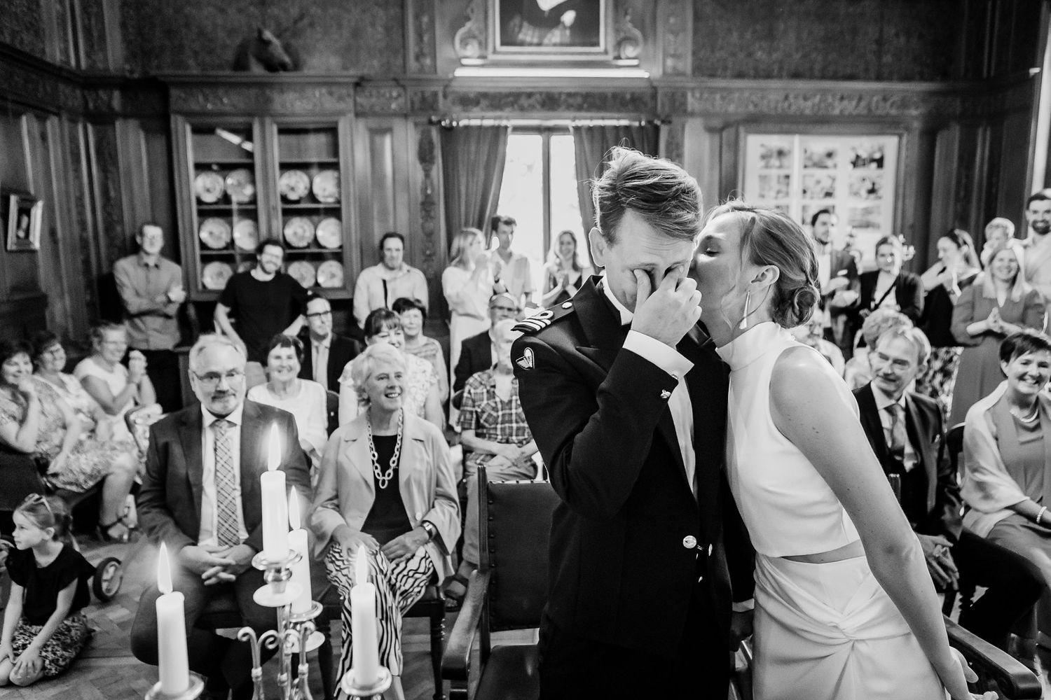 Black and white wedding reception photos show guests celebrating and dancing at an elegant venue.