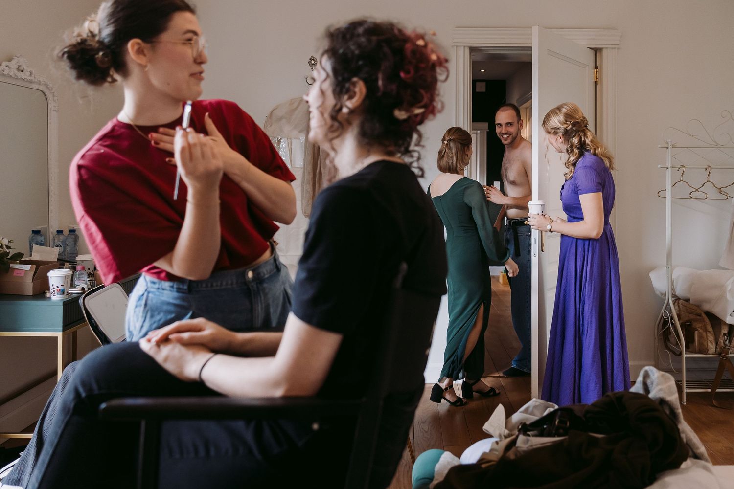 A couple dances together in a ballroom dance class while others practice in the background.