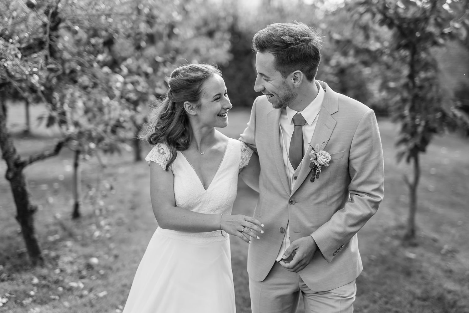 Black and white wedding photos showing romantic moments between newlyweds in an outdoor garden setting.