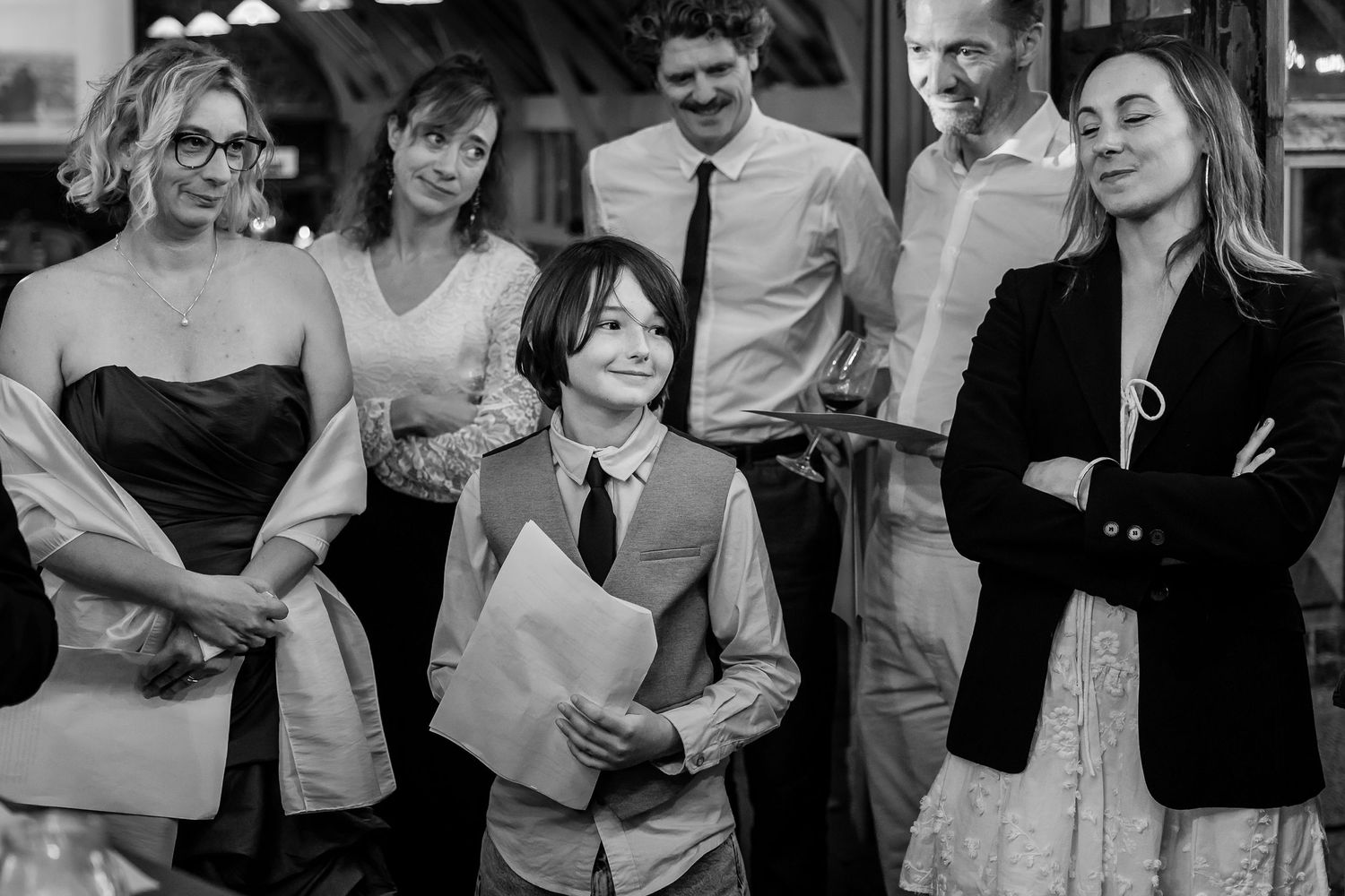 Black and white photo montage showing candid moments at a wedding reception with people dancing and celebrating.
