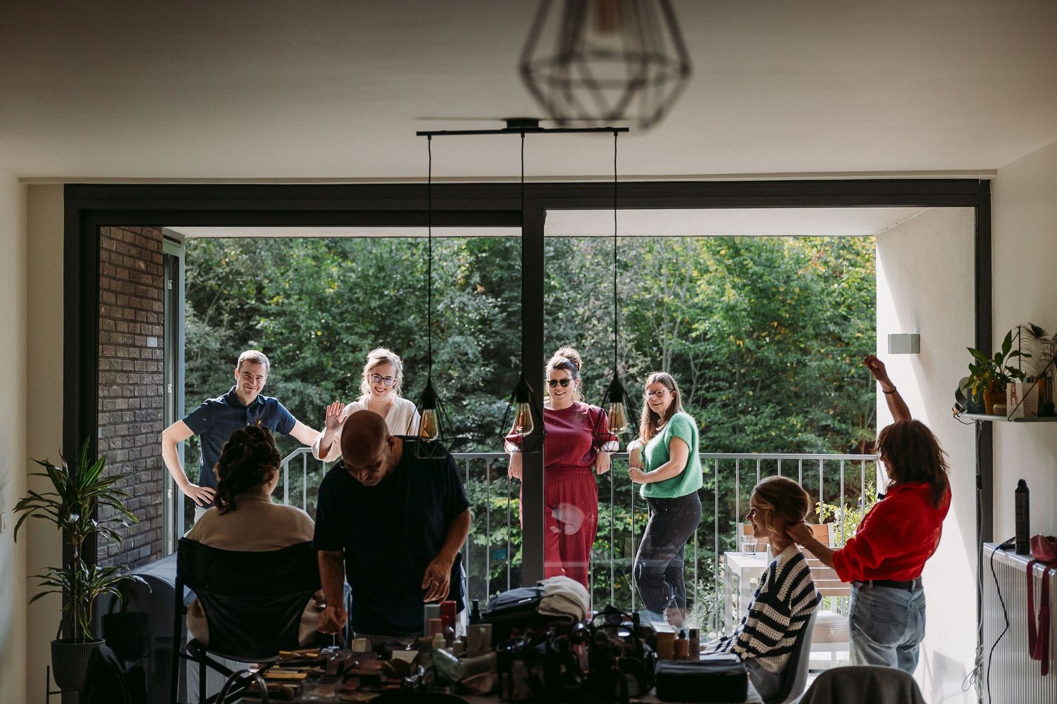Students gather in a modern classroom with large windows and natural light for a group activity.