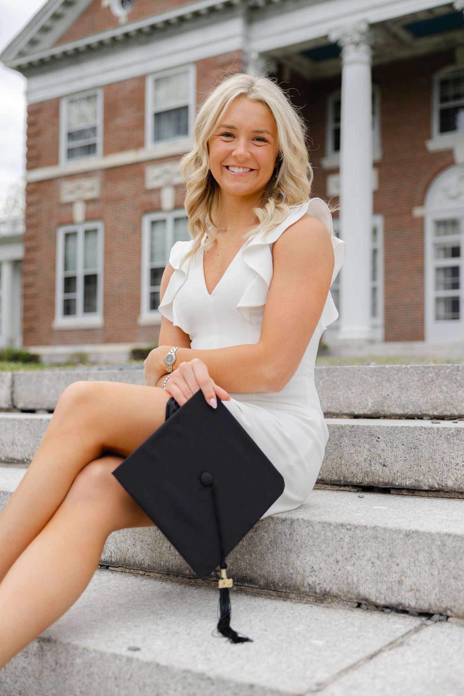 College senior graduation portraits in Massachusetts with natural light photography and spring campus scenery.