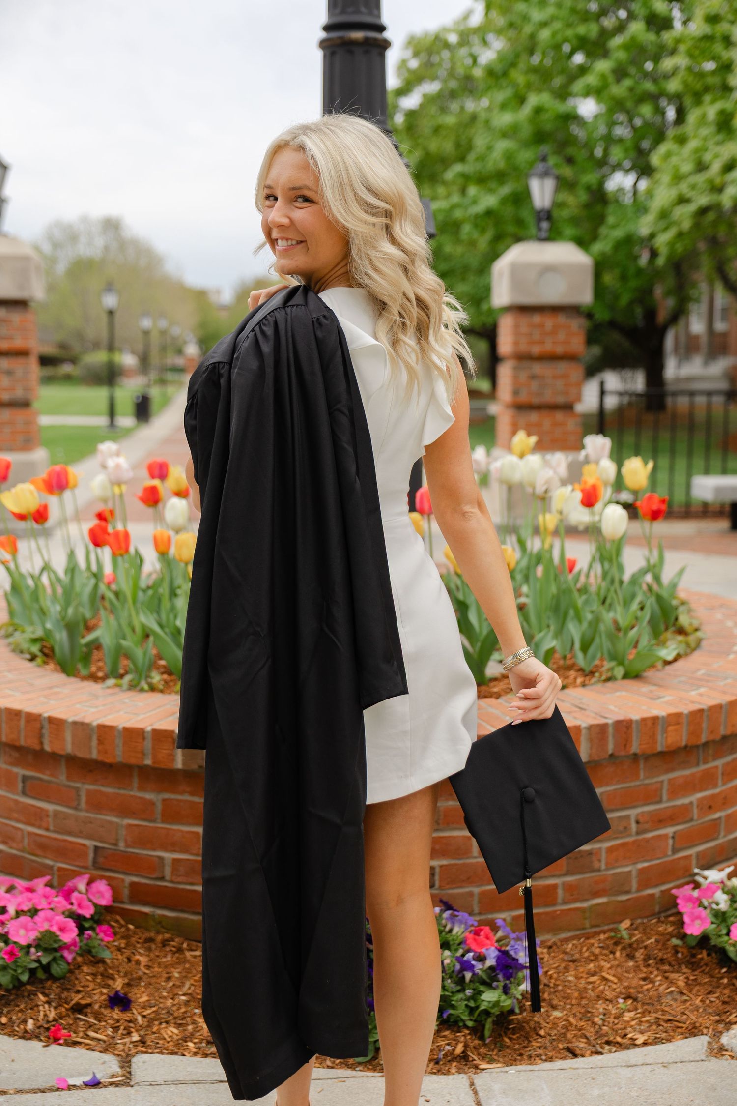 College senior graduation portraits in Massachusetts with natural light photography and spring campus scenery.