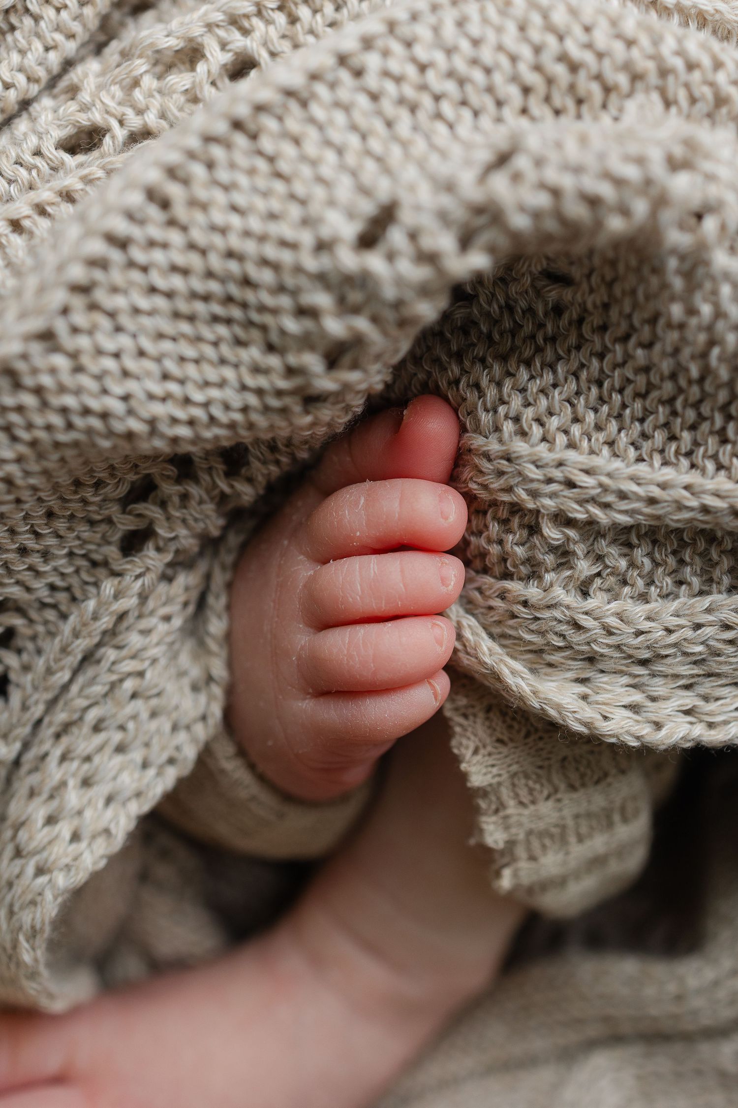 Soft detail of tiny newborn baby feet during studio newborn session in Minneapolis, Kansas