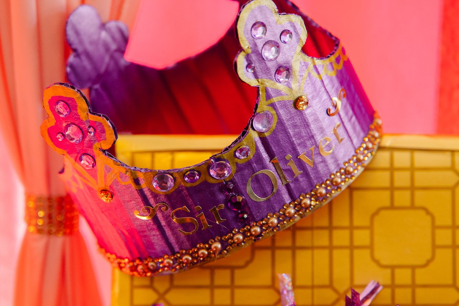 Colorful handmade birthday crown decorated with gems and glitter for a royal cat birthday celebration.