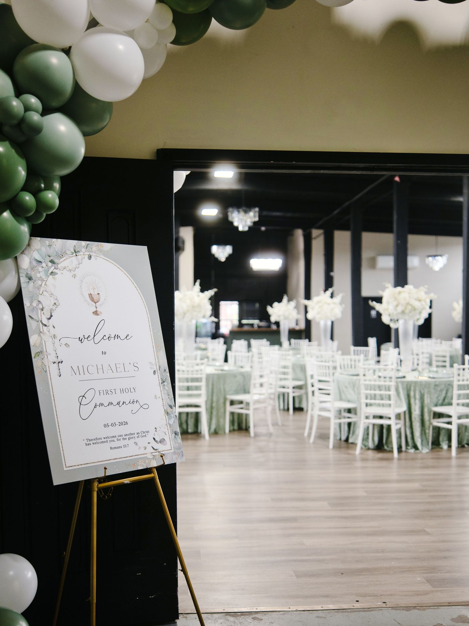 Welcome sign for Michael's First Holy Communion with green and white balloon arch decor.