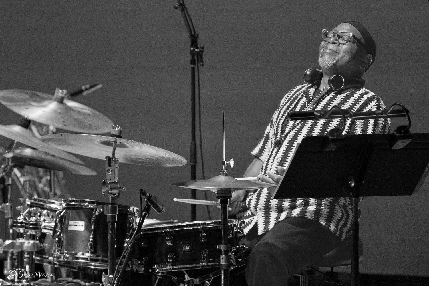 Lewis Nash finishes a jazz drumming solo with a lean back and flourish. At the MIM in Phoenix with The Nash Collective.