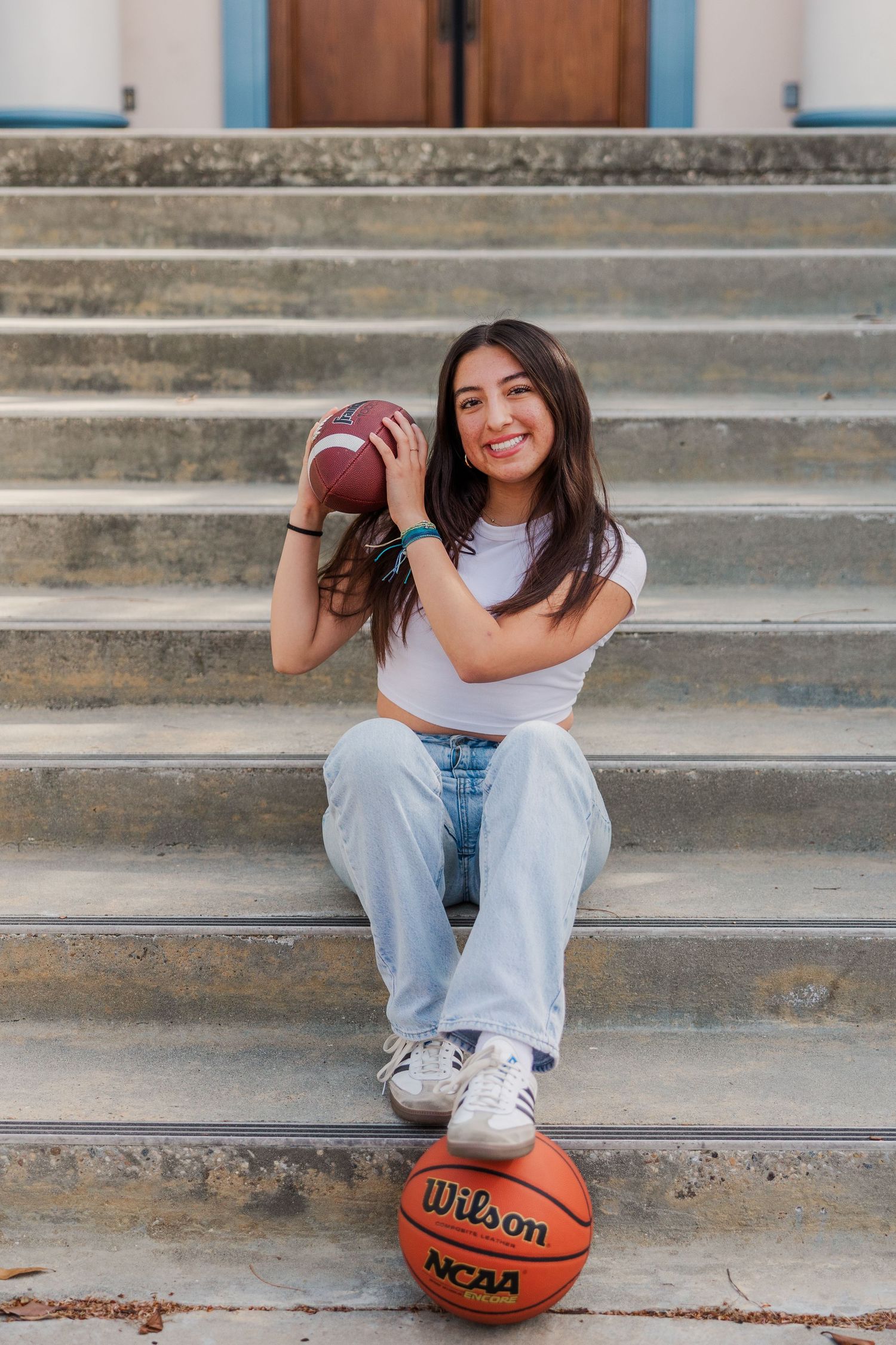 A series of casual lifestyle photos on concrete steps featuring white sneakers, denim jeans and a basketball.