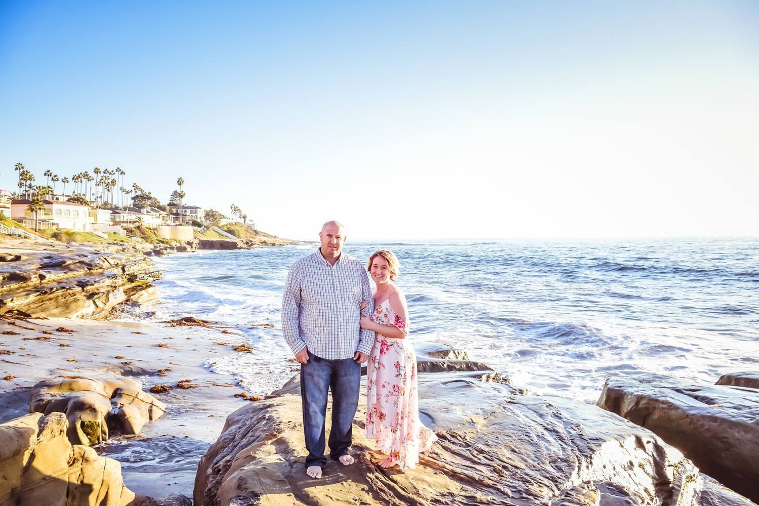 Couple enjoying a romantic sunset along the rugged La Jolla coastline in San Diego.