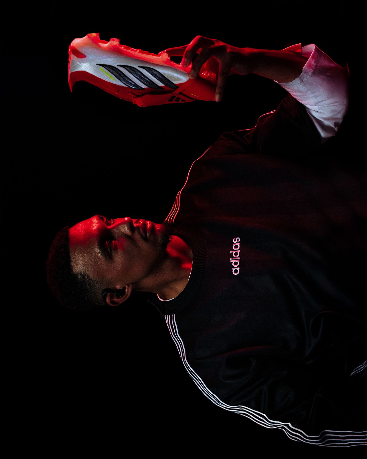 Dramatic low-light sports portraits showing silhouettes and red lighting against dark background.