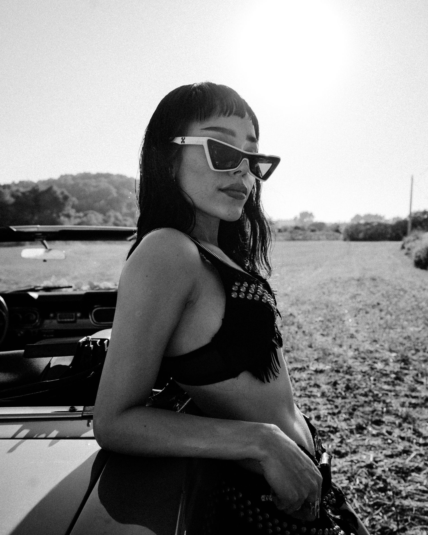 Black and white photo series capturing moody portraits with a vintage automobile.