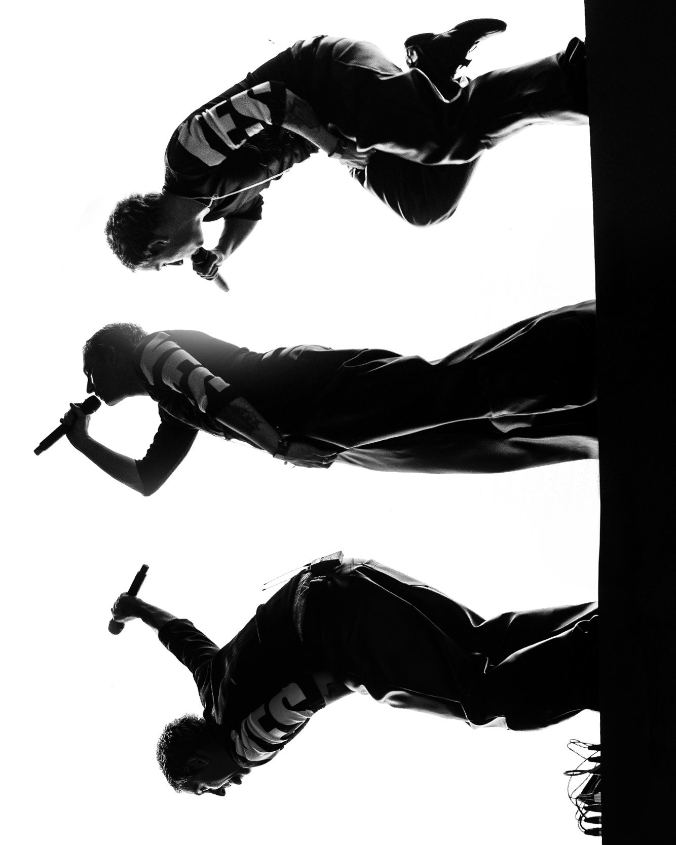 High contrast black and white figures in motion against white background.