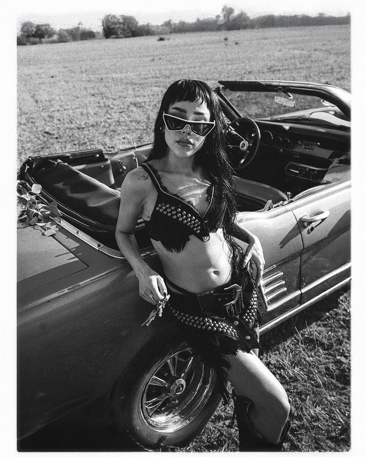Monochrome fashion photos featuring a classic car and retro styling.