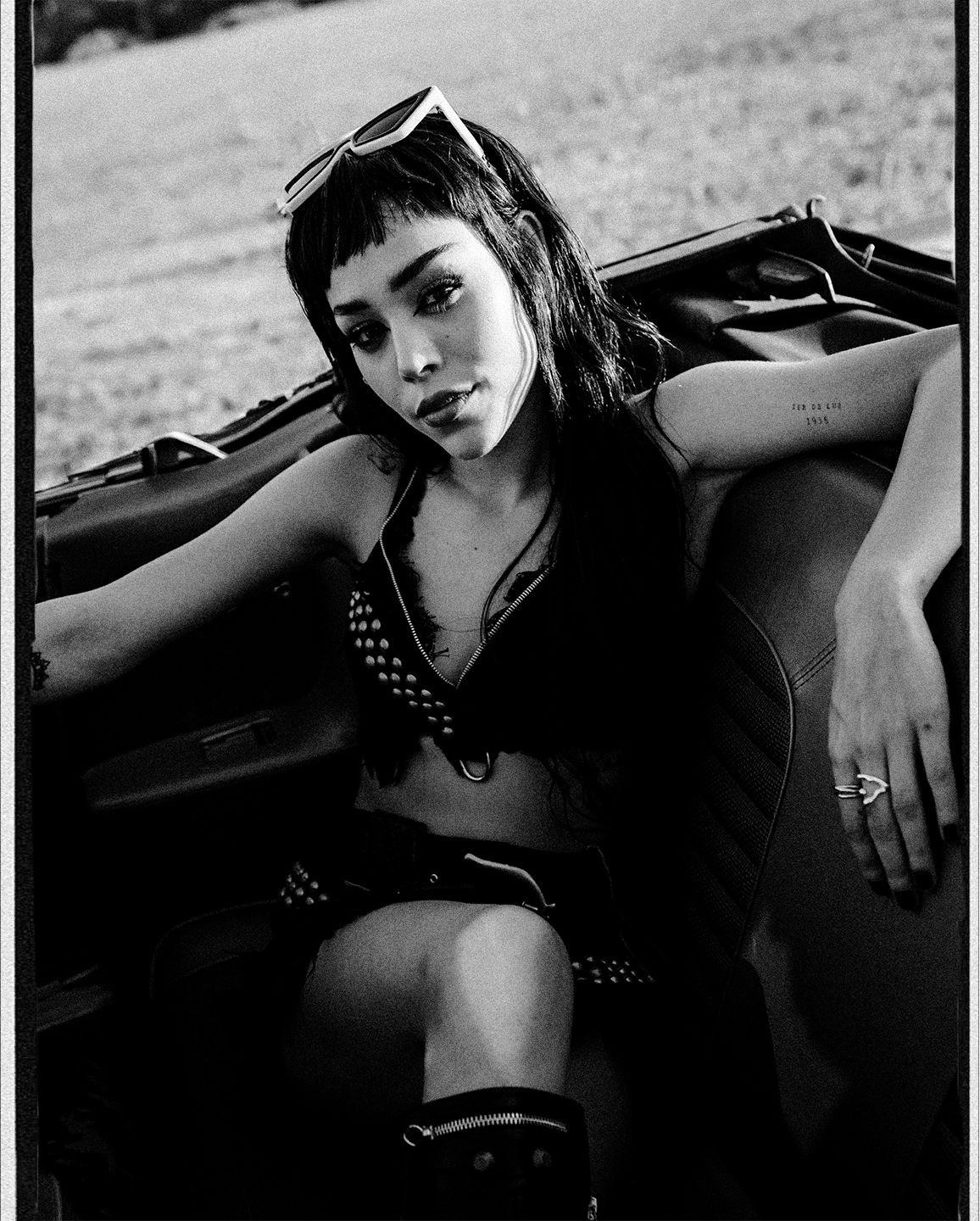 Artistic black and white fashion photographs taken with a classic car.