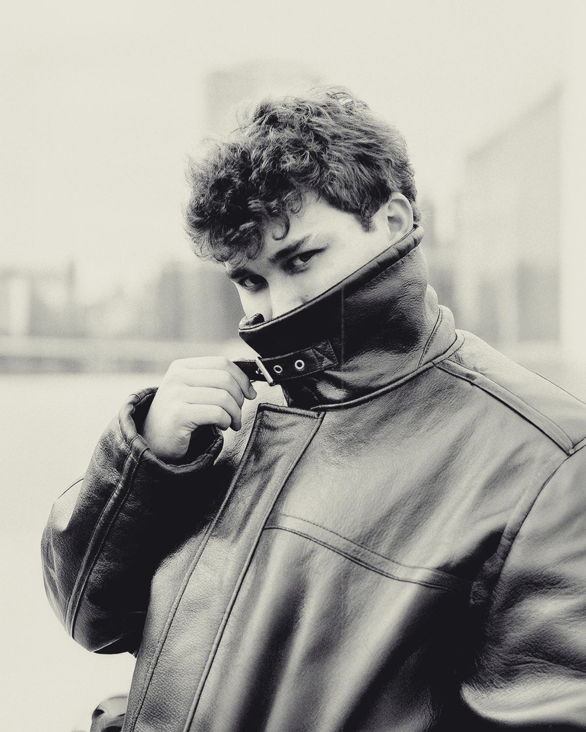 Profile sequence of someone in a leather jacket looking down in moody lighting.