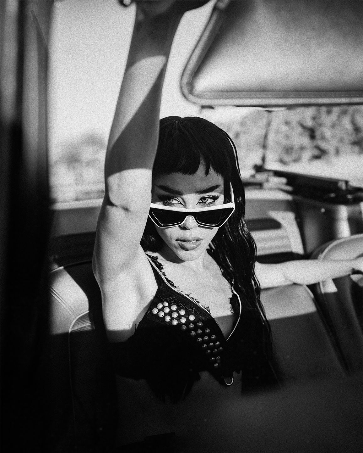 Black and white portrait series showing a vintage-styled fashion scene in a car.