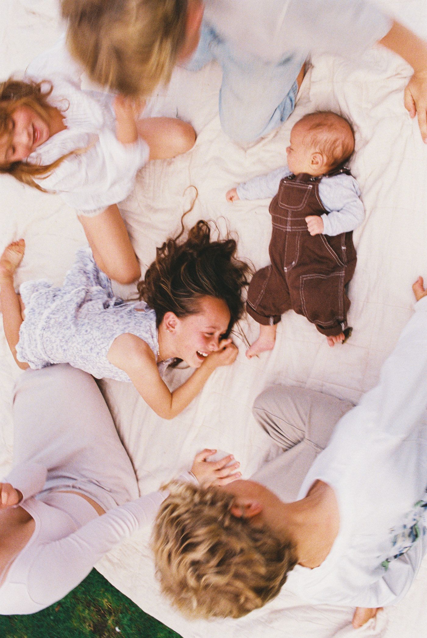 A montage of people lying down on a white surface while wearing light colored clothing.