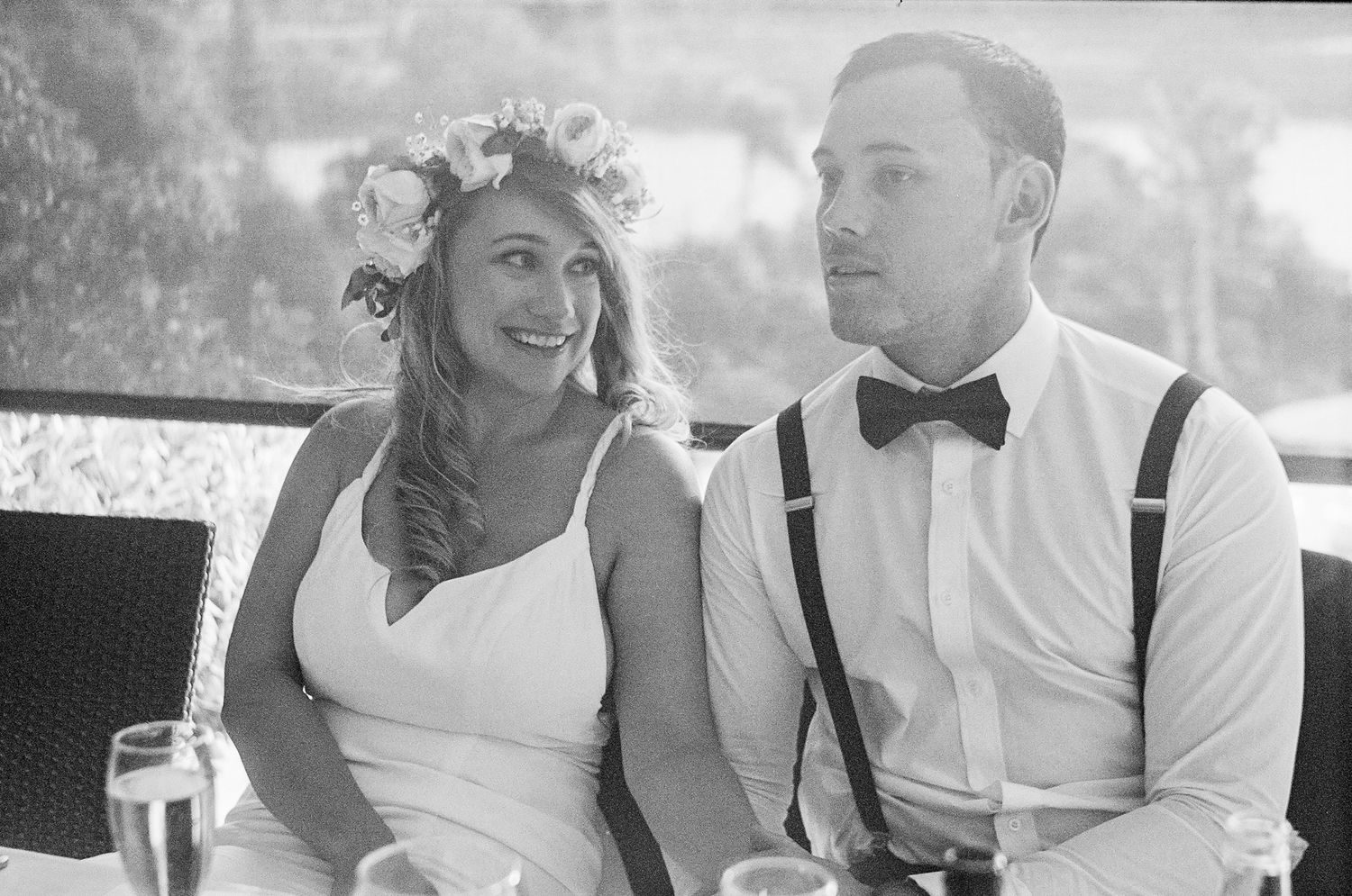 A romantic black and white photo collage showing tender moments between a bride and groom on their wedding day.