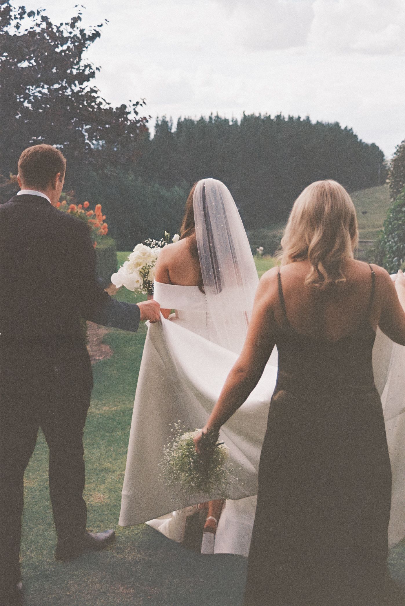A series of candid wedding photos showing guests and the bridal party gathered outdoors with trees in the background.