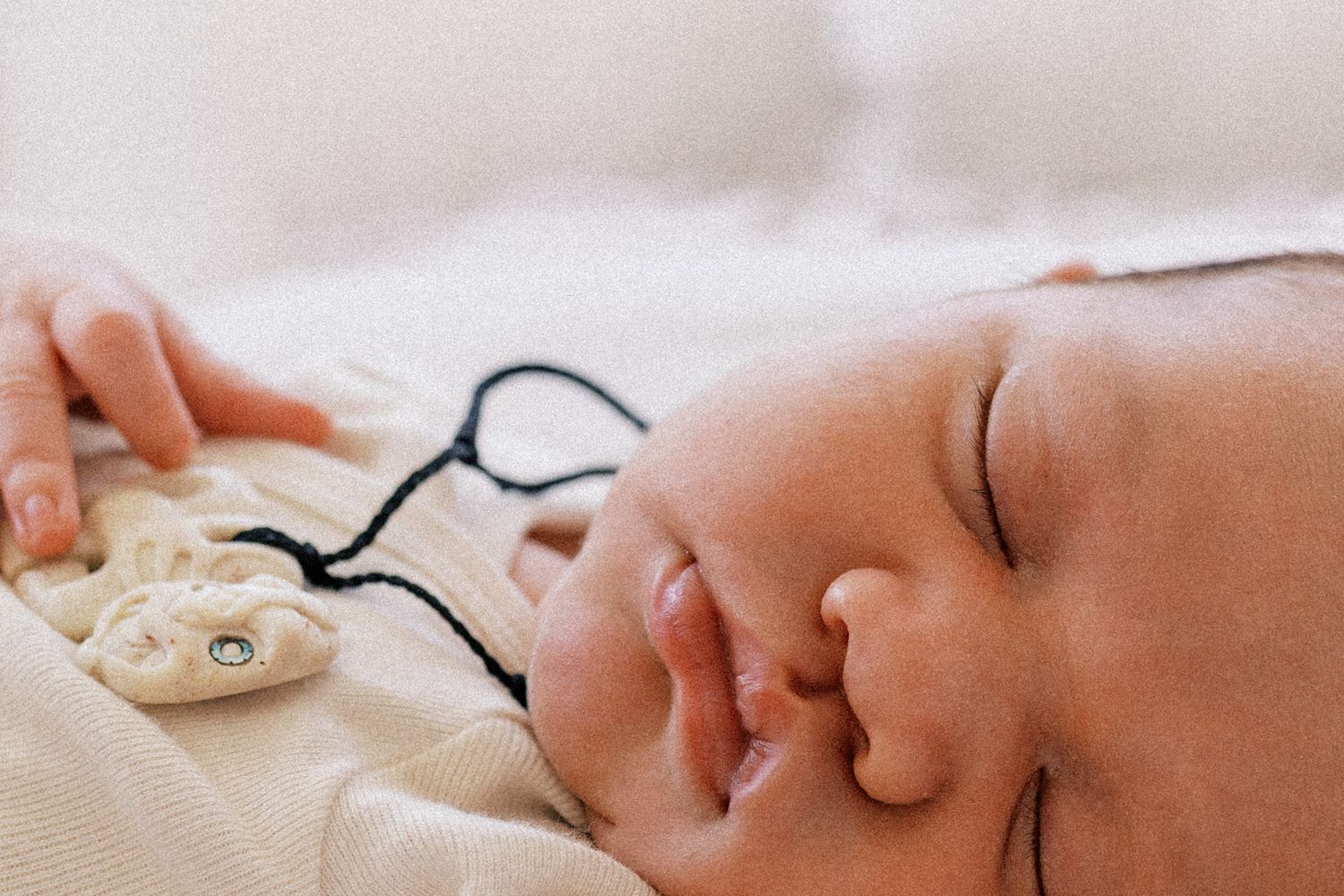 Five connected images showing a sleeping baby in different poses with soft lighting and peaceful expressions.