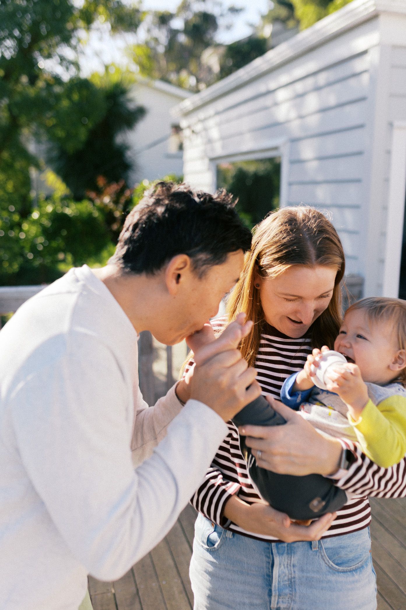 Family moments captured in sequence showing playful interaction between parent and child outdoors on sunny day.