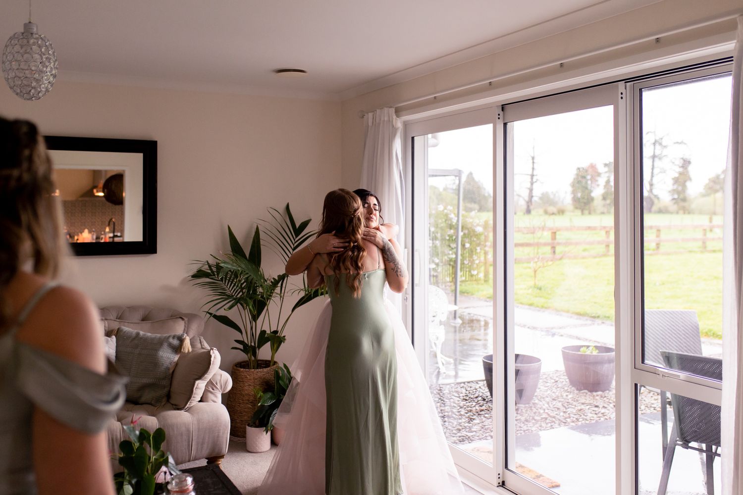A bridal preparation scene with natural light streaming through large windows.