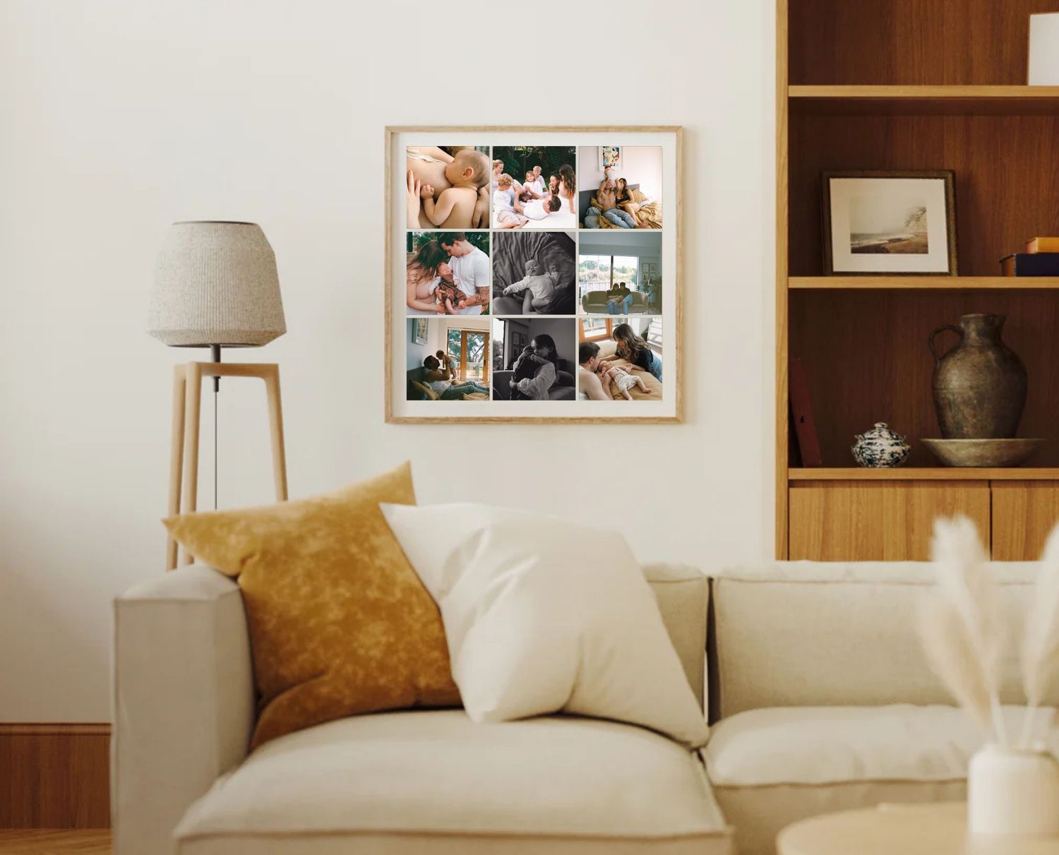 A cozy living room interior with a beige sofa, photo collage wall art, wooden shelving, and modern table lamp.
