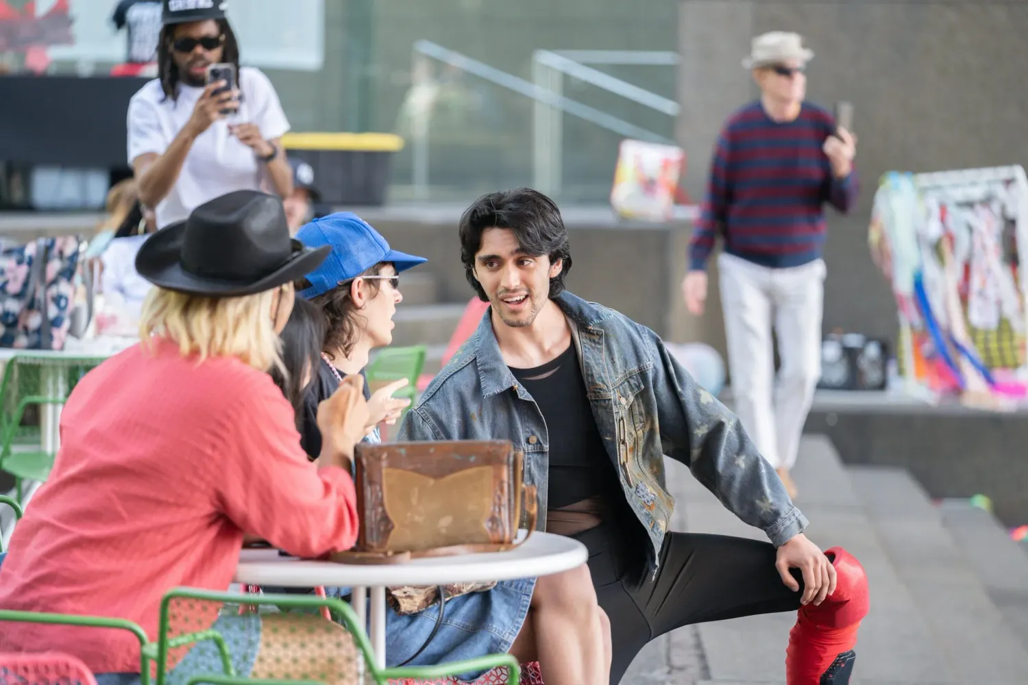 Wrestling match performers engage with spectators during an outdoor entertainment event.