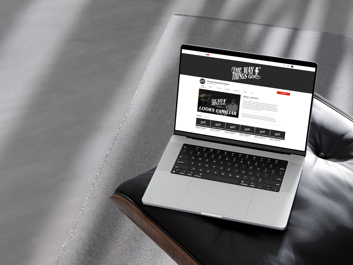 Laptop screen showing a website design mockup on a gray background with minimalist interface elements.
