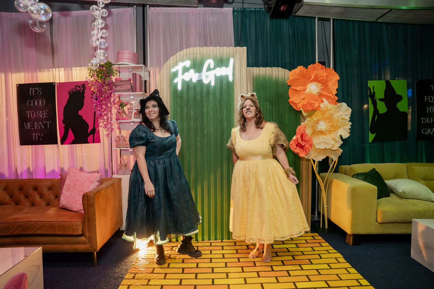 Guests mingling at a festive indoor party with colorful lighting and decorative elements.