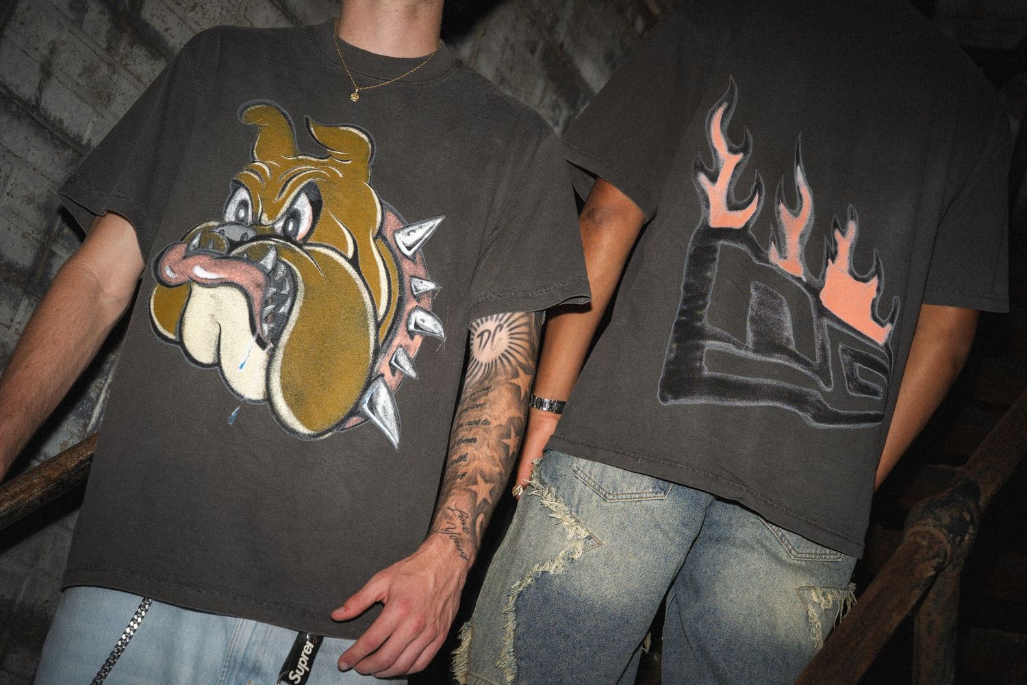 Two graphic t-shirts displayed side by side featuring a cartoon bulldog and flames design.