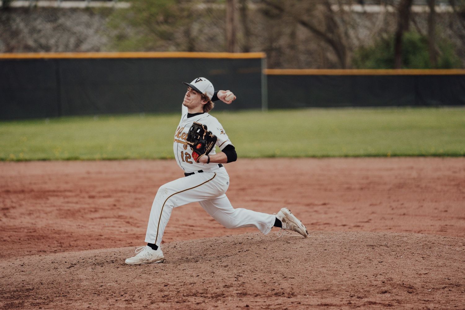 Baseball players spread out in defensive positions on a sunny field.