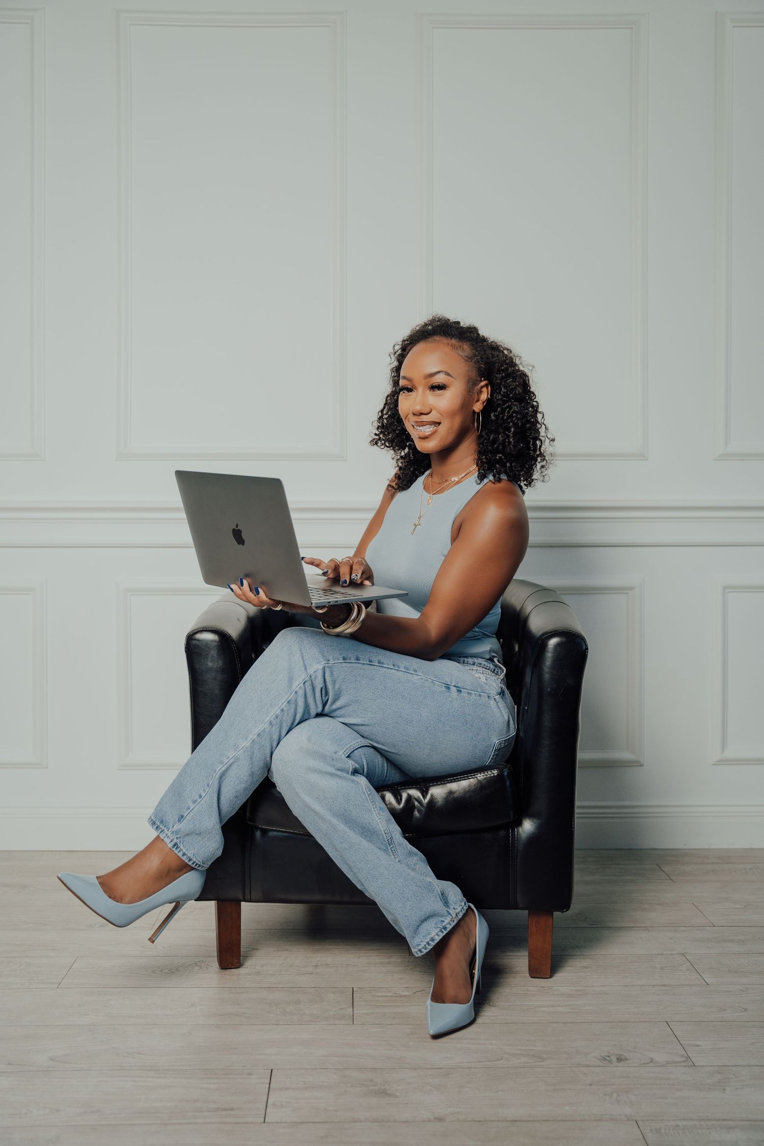Lifestyle business photo showing casual work setup in modern interior with leather chair.