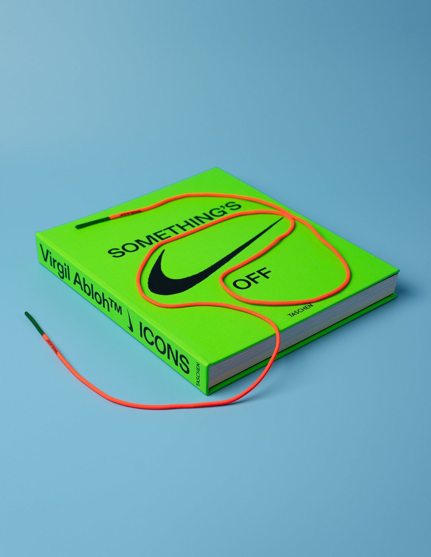 Minimalist green book photographed from different angles against blue background.