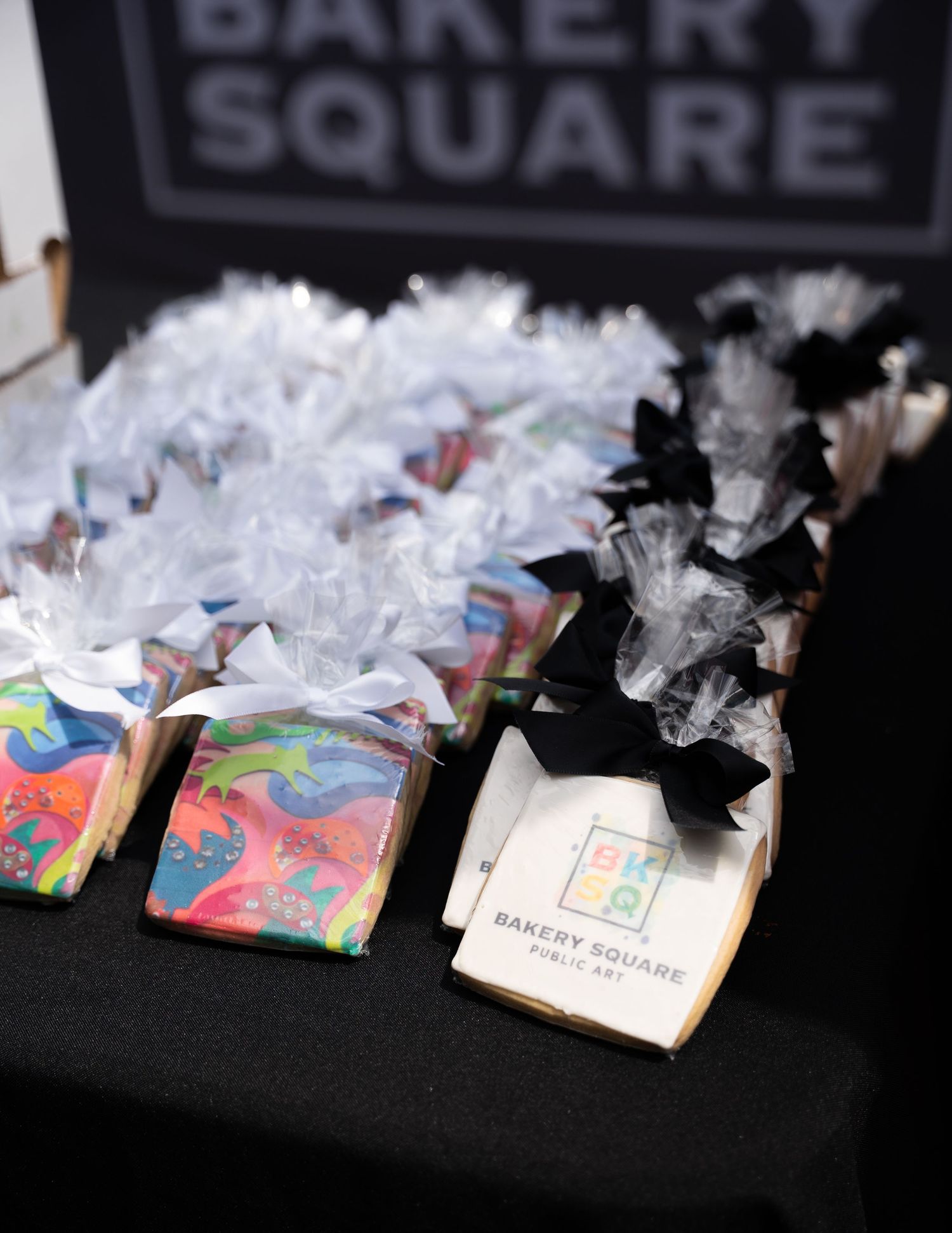 Colorfully wrapped party favors and gift bags displayed at a Bakery Square branded event.
