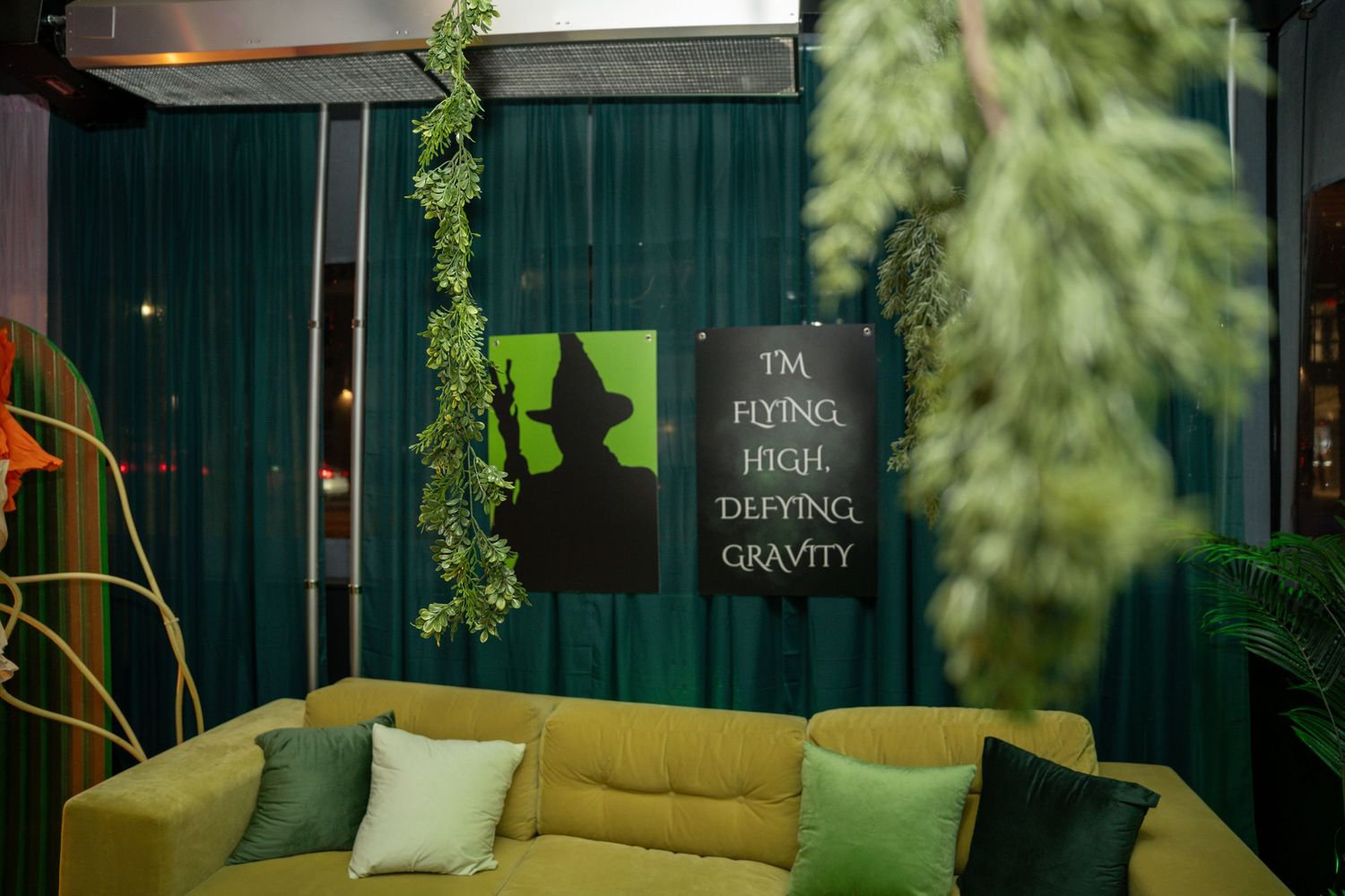 Modern event venue with green decor and stylish seating arrangements.