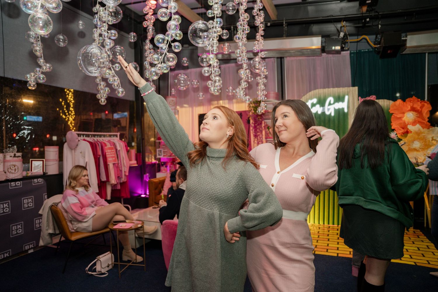 Social event space decorated with hanging crystal ornaments and colorful ambient lighting.