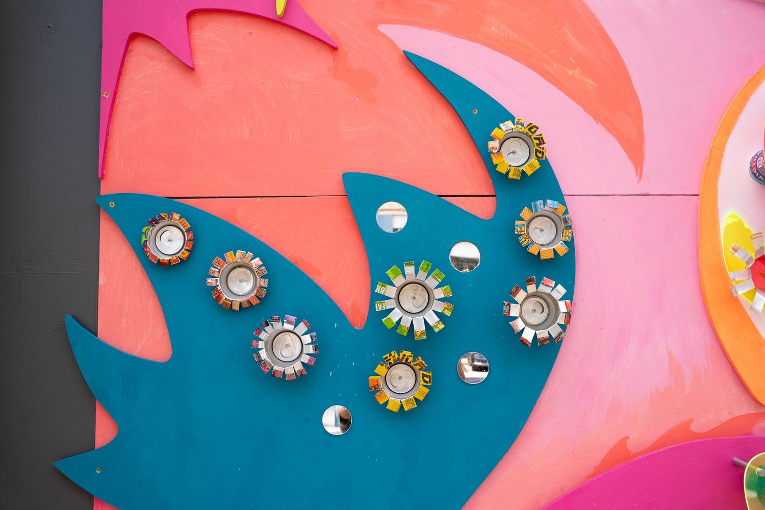 Decorative pink and blue star shapes adorned with crystal or rhinestone embellishments in a vibrant wall art display.