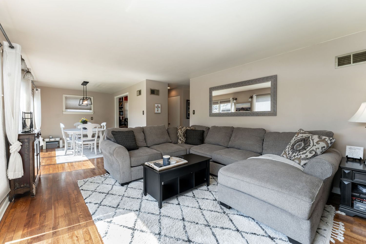 Modern apartment interior collage showing living room, bedroom, and hallway with hardwood floors and contemporary decor.