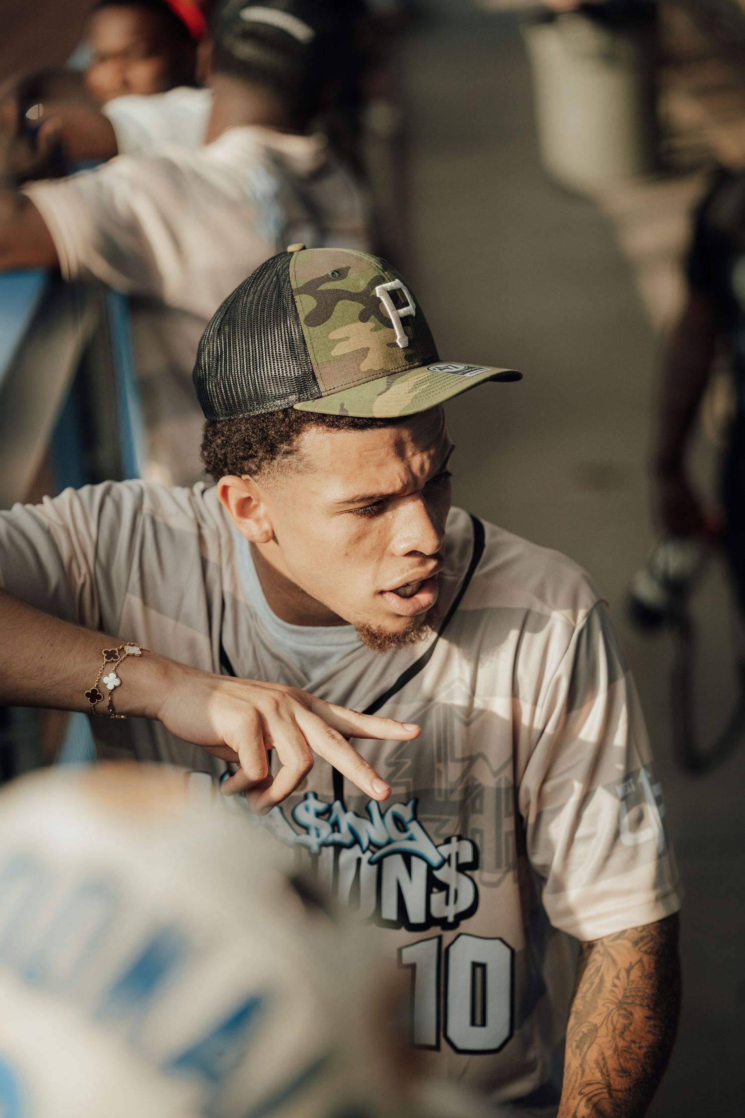 A person in a gray t-shirt and baseball cap shown in a series of candid motion shots.
