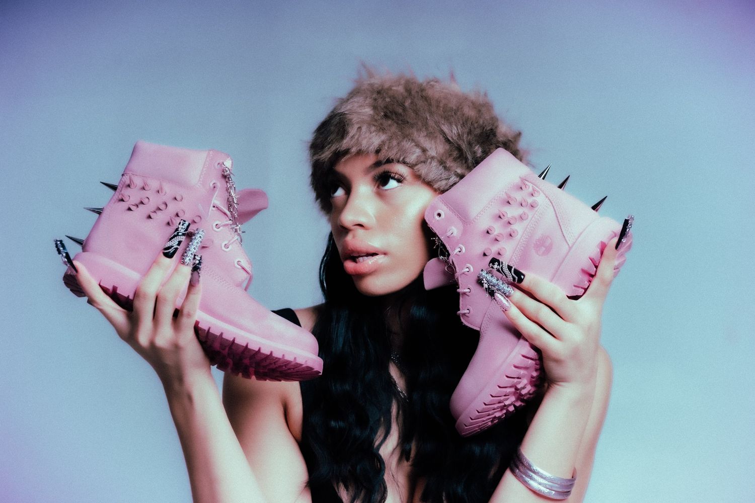 Multiple playful poses of a person wearing pink accessories against a purple background.