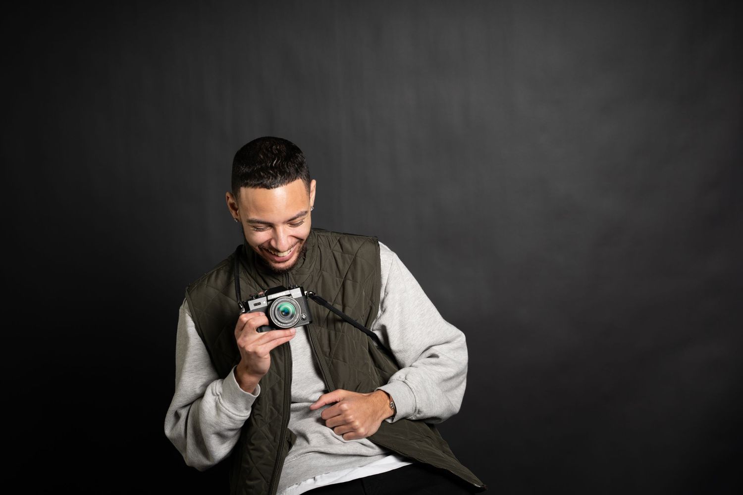 Black and white studio portraits of a photographer with vintage camera.